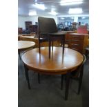 A teak circular extending dining table and four Elliotts of Newbury teak dining chairs