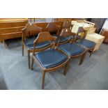 A set of six Danish style teak and black vinyl dining chairs