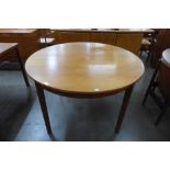 A McIntosh teak circular extending dining table