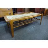 A teak and tiled top coffee table
