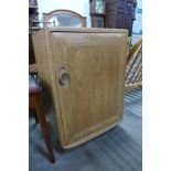 A small Ercol Windsor single door bedside cupboard