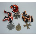 Four German medallions, Merit Cross with swords, one other Merit Cross, Iron Cross and one other