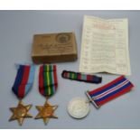 Three WWII medals with ribbons, paper and box addressed to Mr D.L. Barnett, Birmingham