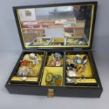 A jewellery box with costume brooches