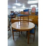 A McIntosh circular teak extending dining table and four chairs