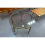An Italian brass and glass topped circular coffee table