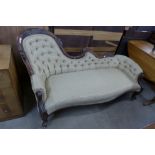 A Victorian style carved mahogany and fabric upholstered chaise longue