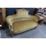 A Victorian carved walnut and fabric upholstered settee