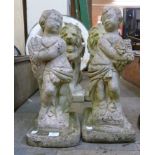 A pair of concrete garden figures of cherubs