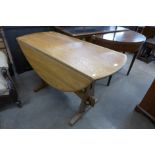 An Ercol style elm drop-leaf table