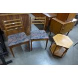 A pair of teak chairs and a teak coffee table