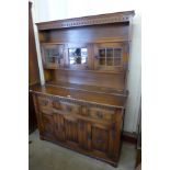 A carved oak linenfold dresser