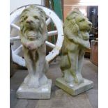 A pair of concrete garden figures of seated lions