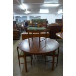A McIntosh circular teak extending dining table and four chairs