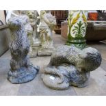 Two concrete garden figures of otters