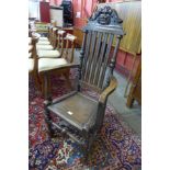A Victorian Jacobean Revival carved oak elbow chair