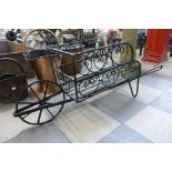 A painted wrought steel wheelbarrow shaped plant pot stand