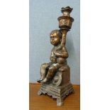 A cast metal cherub plant stand