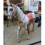 A painted metal fairground ride horse seat