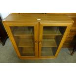 An Ercol Blonde ash two door bookcase