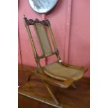 A small Victorian walnut folding campaign chair, the back rest set with ivory cabochons. This lot is
