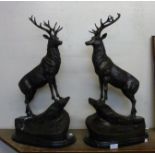 A pair of large French style bronze figures of stags, on black marble socles
