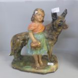 A plaster model of a girl with German Shepherd dog