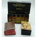 A miniature leather bound Holy Bible, a set of five miniature perfume bottles and a snuff box