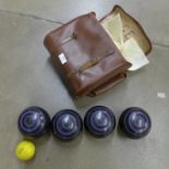 A set of four lawn bowls and a jack in a leather case