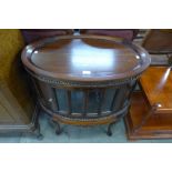 A Victorian style mahogany oval cabinet on stand