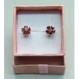 A pair of 9ct gold ruby and diamond cluster ear studs, 1.3g