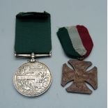 A Victoria British Army For Long Service In The Volunteer Force Medal, name erased, and a