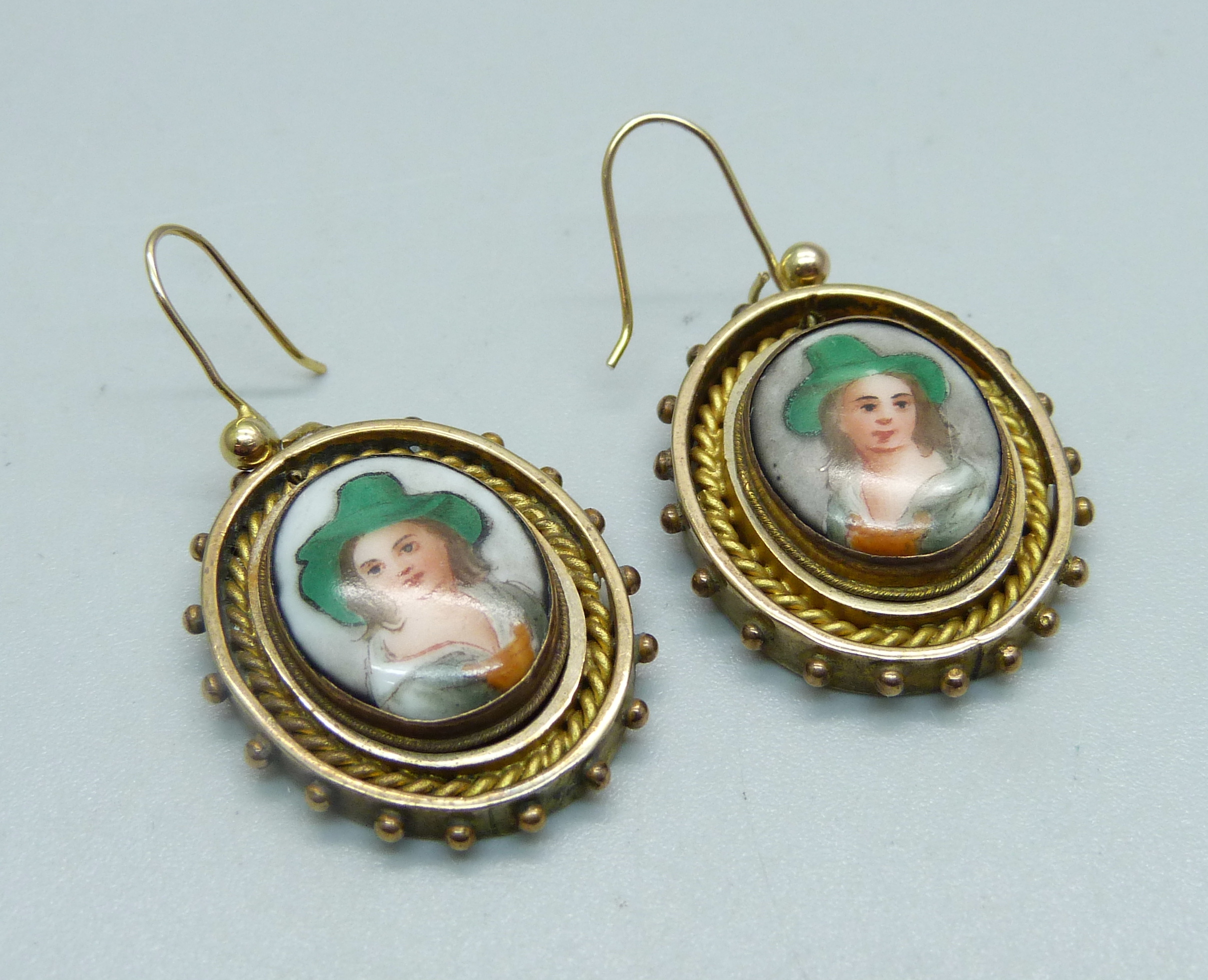 A pair of gilt metal portrait earrings