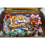 A collection of costume jewellery in a rosewood box
