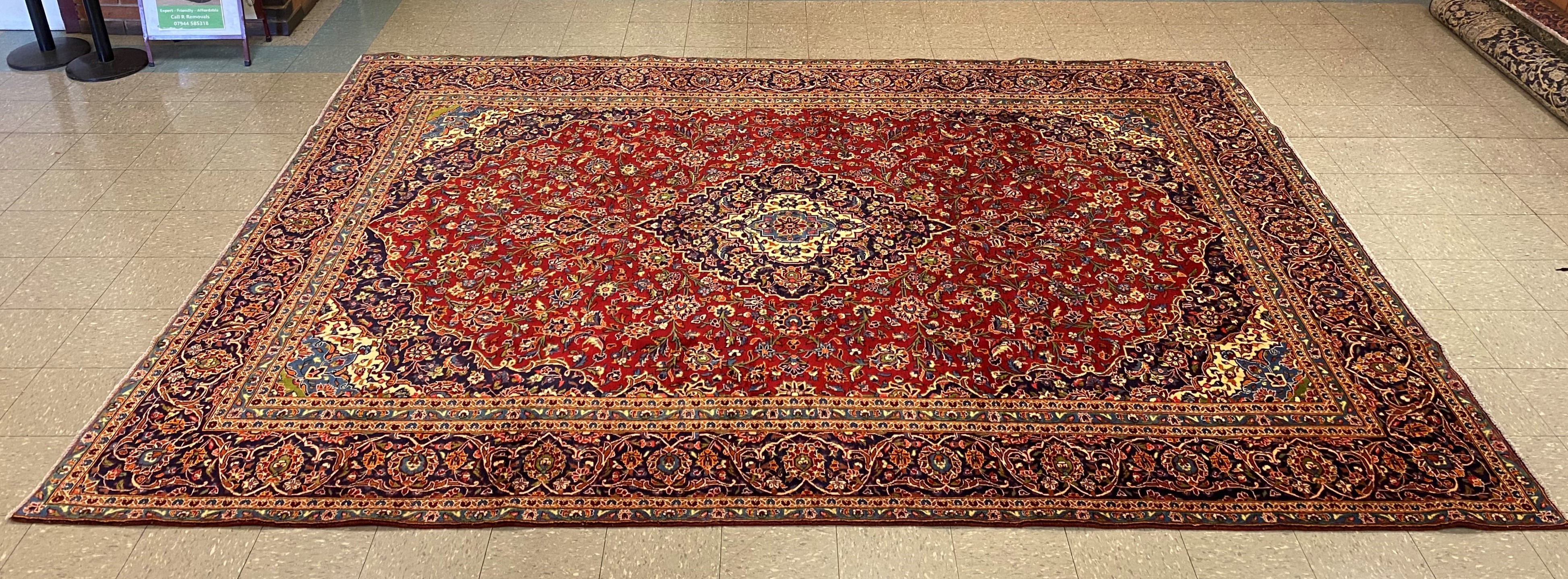 A large Persian red ground Kashan rug, 409 x 294cms
