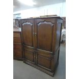 A George III style Ipswich oak four door TV cabinet