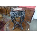 A late 19th Century Chinese carved rosewood and marble topped octagonal jardinere stand