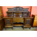 A late Victorian Warings carved mahognay breakfront sideboard