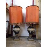 A pair of French gilt metal and glass table lamps