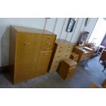 A G-Plan Brandon light oak bedroom suite, comprising; a chest of drawers, tallboy, dressing table,