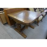 A carved oak draw leaf table
