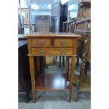 An inlaid mahogany three drawer lamp table