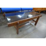 A teak and glass topped rectangular coffee table