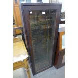 An early 20th Century stained pine wall hanging gun cabinet