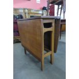 A teak drop-leaf table