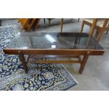 A teak and glass topped rectangular coffee table