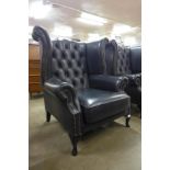A black leather Chesterfield Wingback armchair