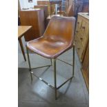 A brown leather and steel framed bar stool