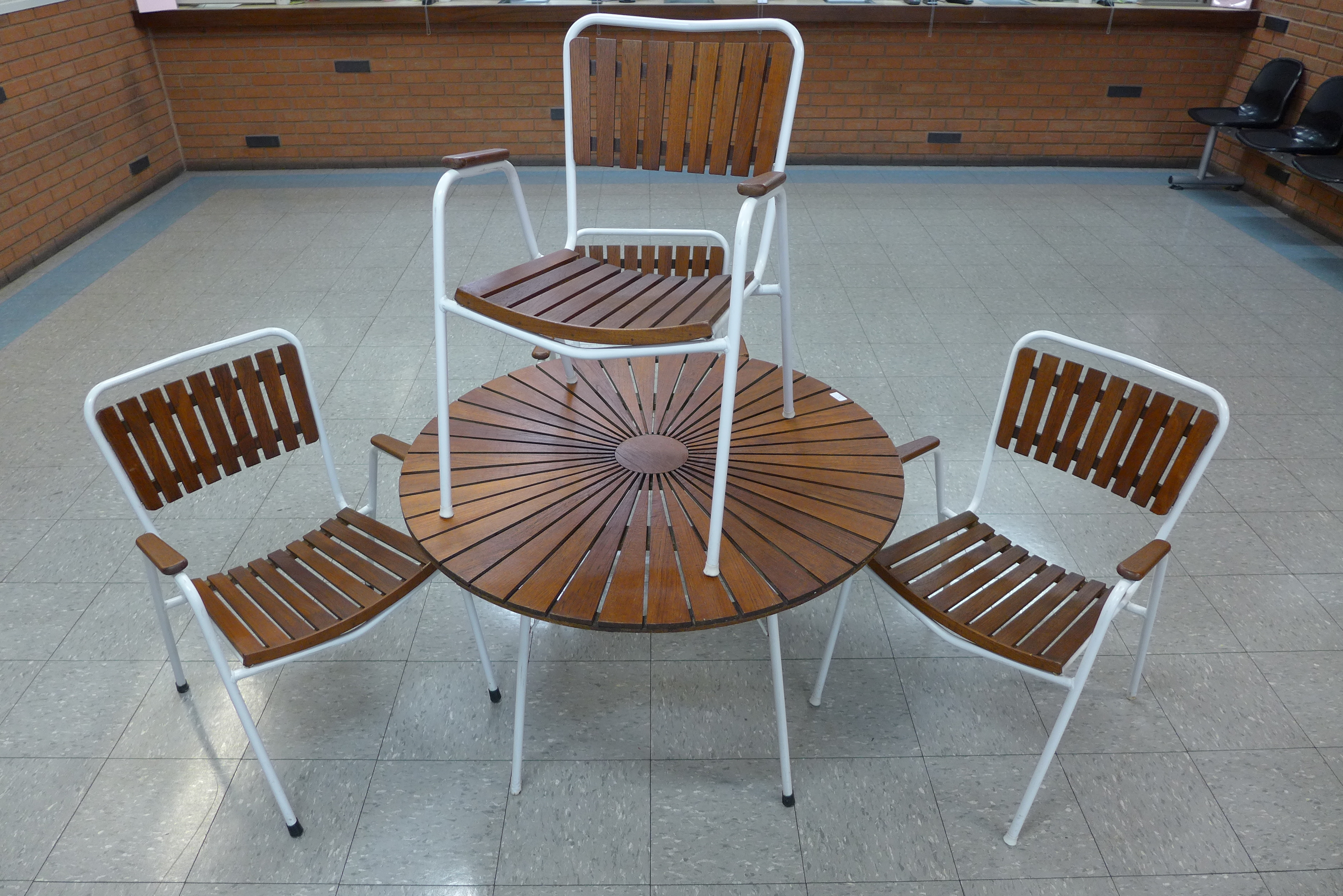 A Danish Daneline teak and white tubular metal garden table and four chairs