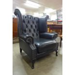 A black leather Chesterfield wingback armchair